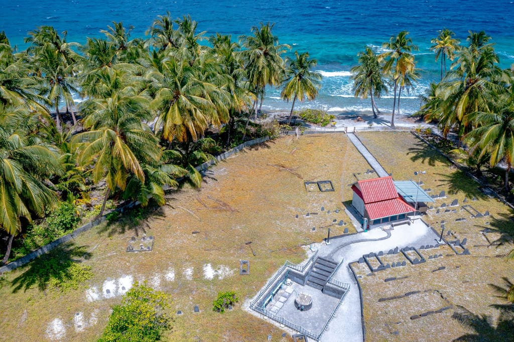 Aerial view of the historic Kederey Miskiy mosque grounds beneath coconut palms